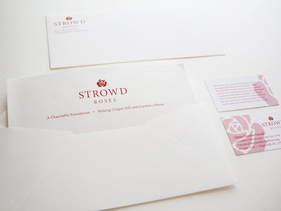 This photo shows the Strowd Roses letterhead, envelope, and business cards. These printed materials are white with the Strowd Roses logo and text in red.