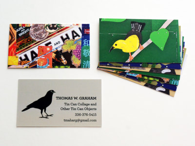 Photo of business cards with the front side a warm grayish taupe background with a simple illustration of a grow facing the text; a pile of the backs of the business cards feature various photos of the artist's tin collages, including a brightly colored one and one with a yellow bird.